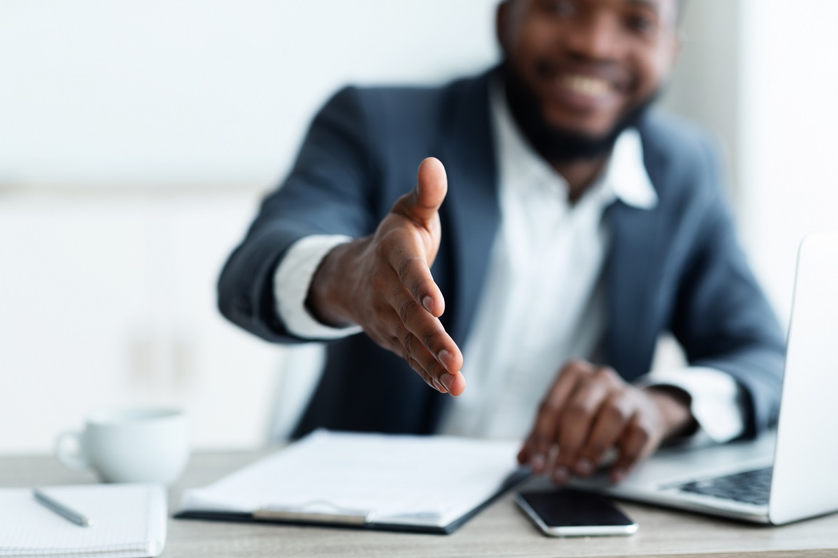 African American businessman extending hand to shake